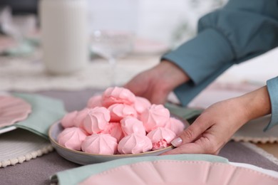 Photo of Woman setting table for dinner at home, closeup