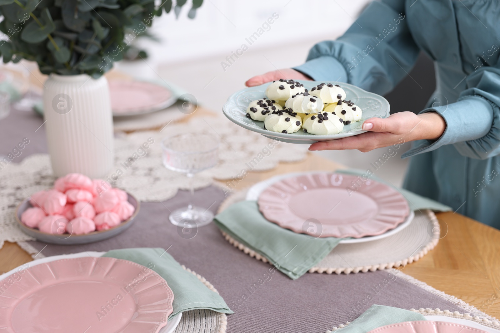 Photo of Woman setting table for dinner at home, closeup