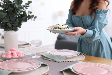 Photo of Woman setting table for dinner at home, closeup