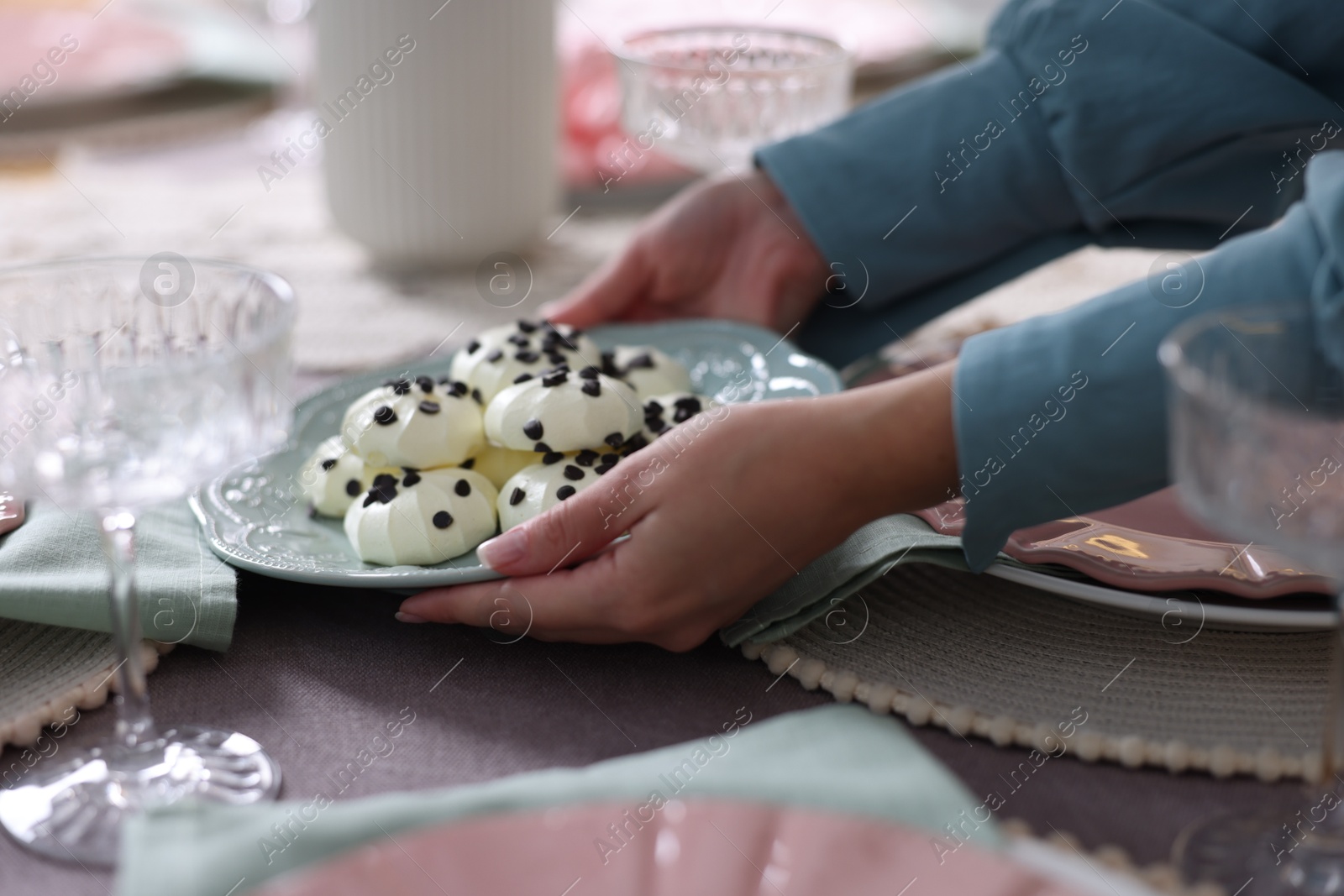 Photo of Woman setting table for dinner at home, closeup