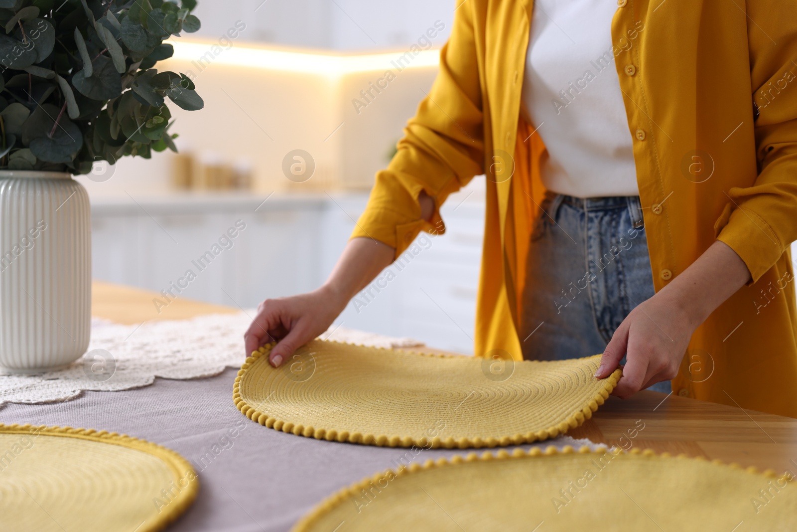 Photo of Woman setting table for dinner at home, closeup