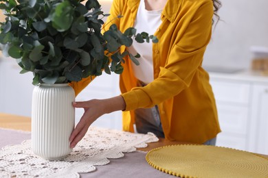 Photo of Woman setting table for dinner at home, closeup