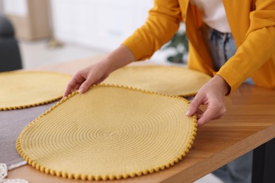 Photo of Woman setting table for dinner at home, closeup