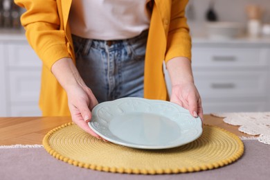 Photo of Woman setting table for dinner at home, closeup