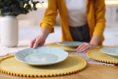 Photo of Woman setting table for dinner at home, closeup