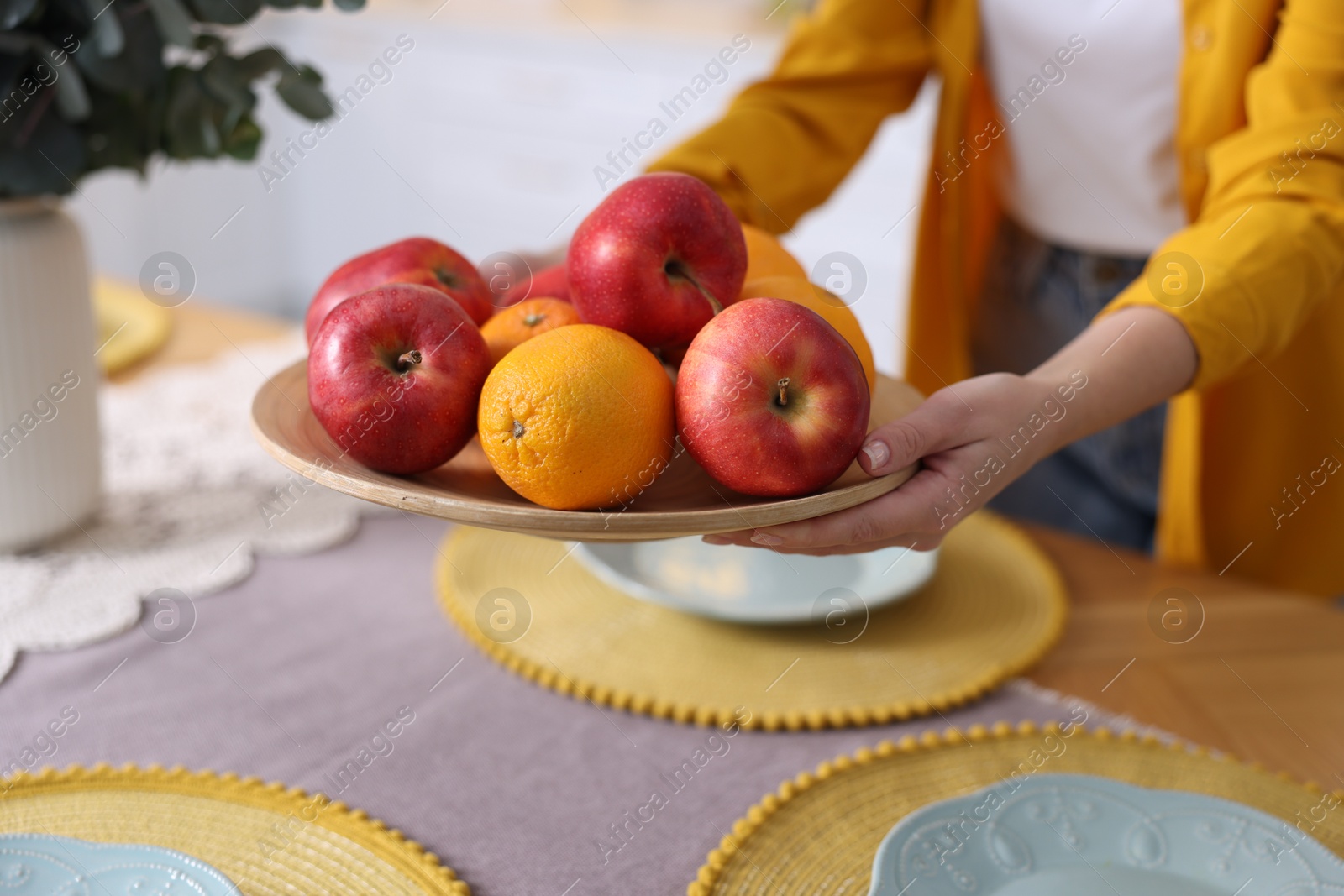 Photo of Woman setting table for dinner at home, closeup