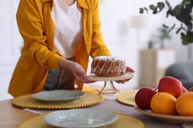 Photo of Woman setting table for dinner at home, closeup