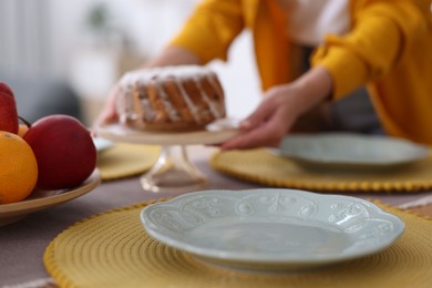 Photo of Woman setting table for dinner at home, closeup