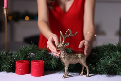 Photo of Woman setting table for Christmas dinner at home, closeup