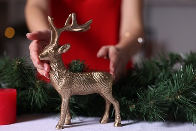 Photo of Woman setting table for Christmas dinner at home, closeup