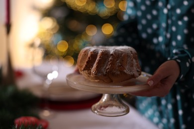 Photo of Woman with delicious sponge cake at home, closeup. Space for text