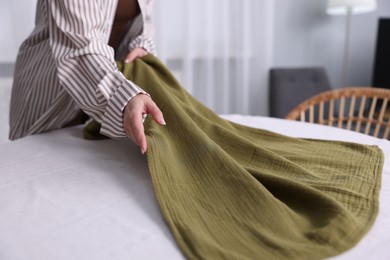 Photo of Woman setting table for dinner at home, closeup