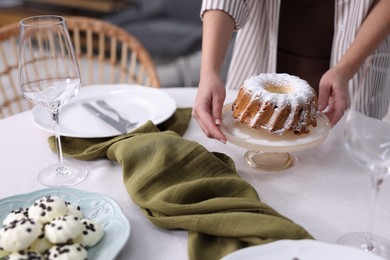 Photo of Woman setting table for dinner at home, closeup