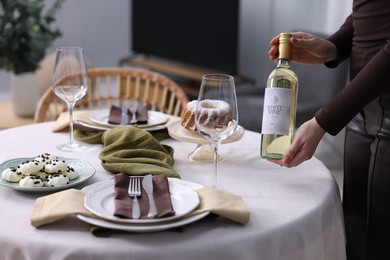 Photo of Woman setting table for dinner at home, closeup