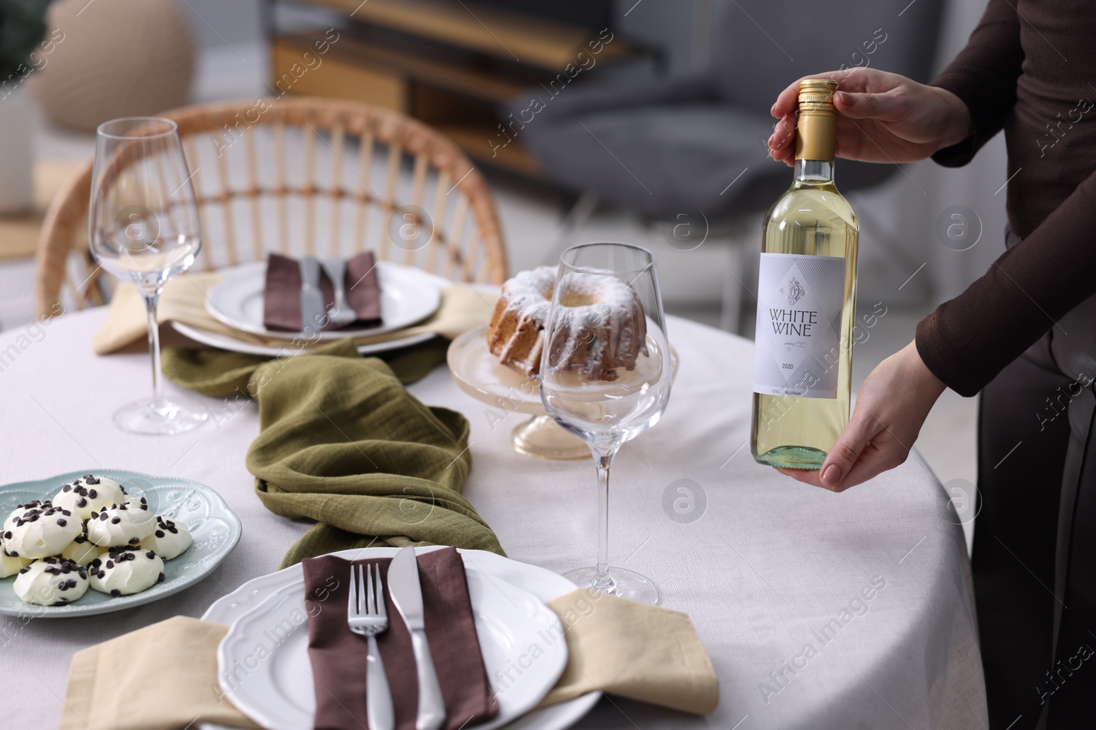 Photo of Woman setting table for dinner at home, closeup