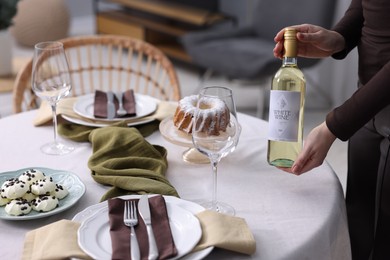 Photo of Woman setting table for dinner at home, closeup