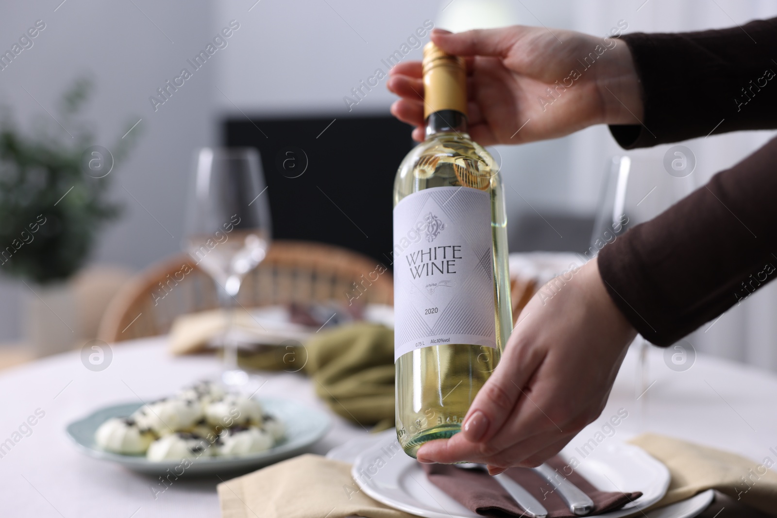 Photo of Woman setting table for dinner at home, closeup