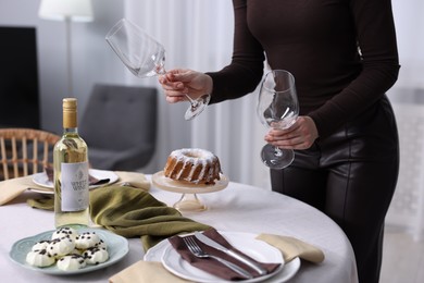 Photo of Woman setting table for dinner at home, closeup