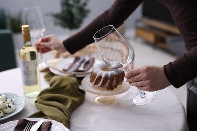 Photo of Woman setting table for dinner at home, closeup