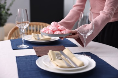 Photo of Woman setting table for dinner at home, closeup