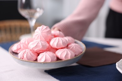 Photo of Woman setting table for dinner at home, closeup