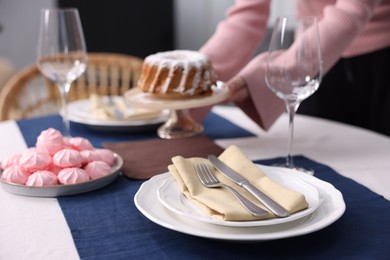 Photo of Woman setting table for dinner at home, closeup