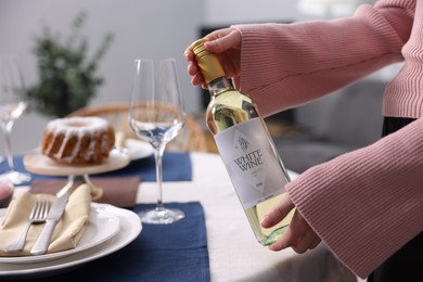 Photo of Woman setting table for dinner at home, closeup