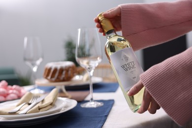 Photo of Woman setting table for dinner at home, closeup