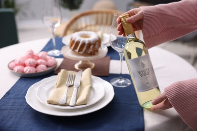 Photo of Woman setting table for dinner at home, closeup