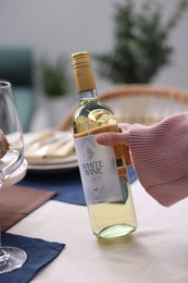 Photo of Woman setting table for dinner at home, closeup