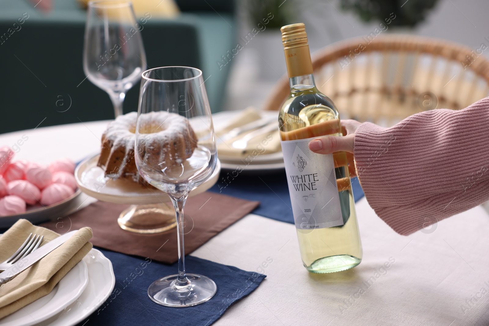 Photo of Woman setting table for dinner at home, closeup