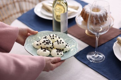 Photo of Woman setting table for dinner at home, closeup