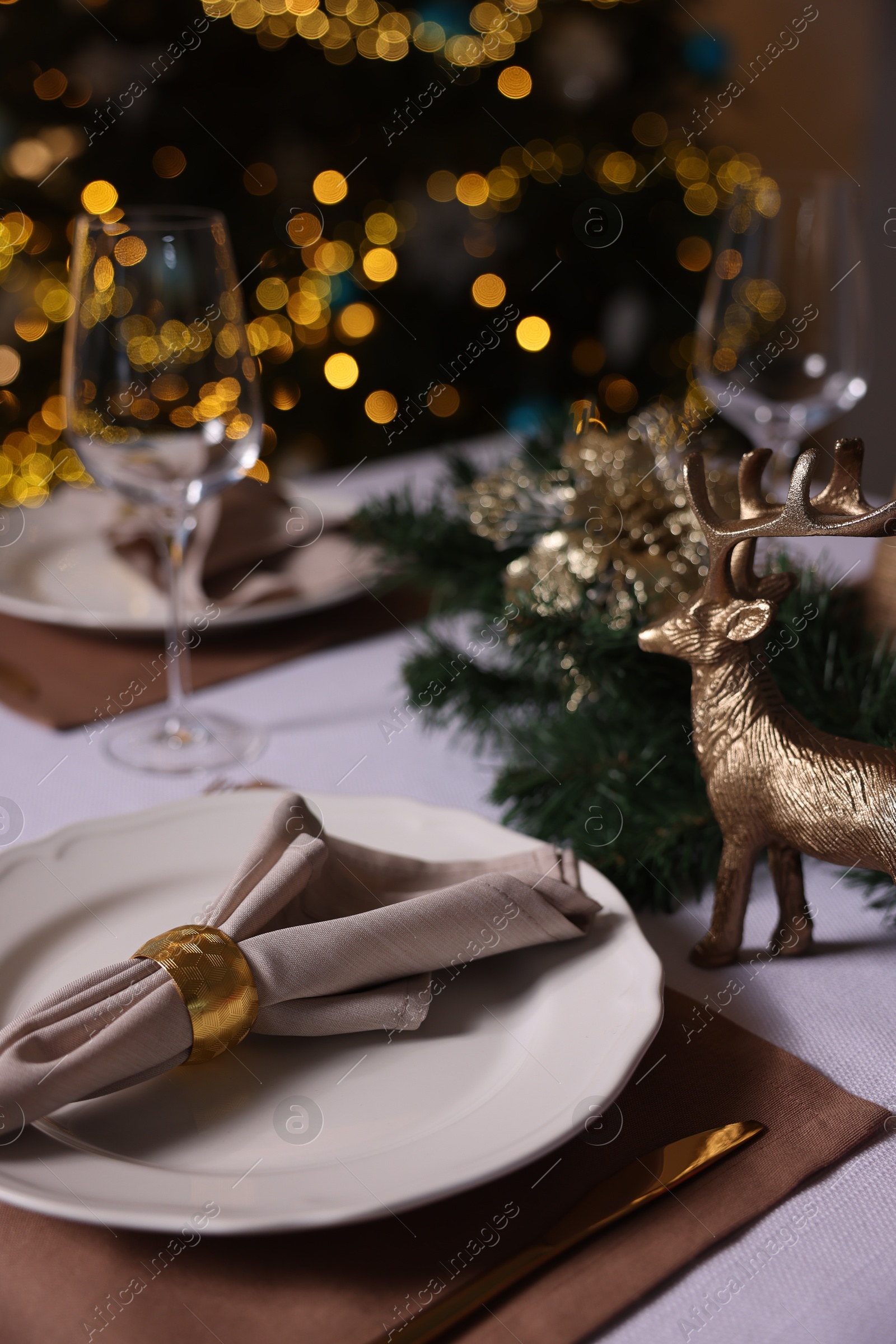 Photo of Festive table setting with dishware, glasses and decor indoors, closeup