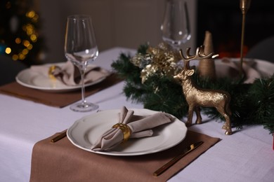 Photo of Festive table setting with dishware, glasses and decor indoors