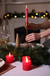 Photo of Woman setting table for Christmas dinner at home, closeup