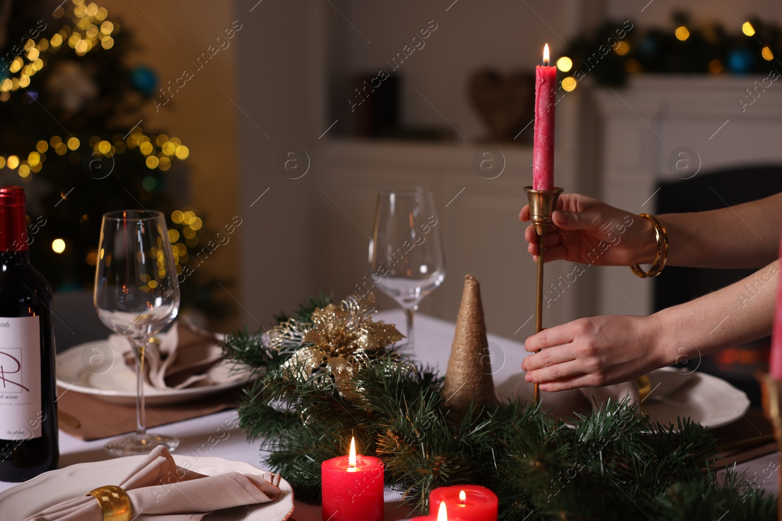 Photo of Woman setting table for Christmas dinner at home, closeup