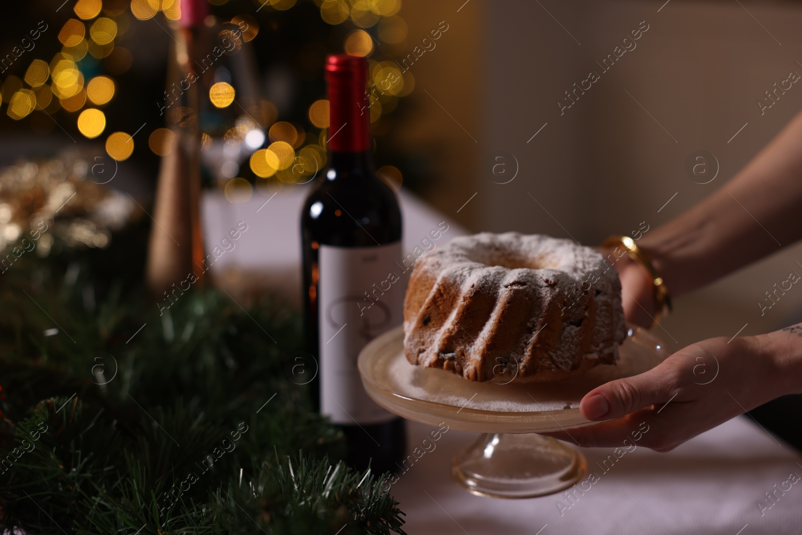 Photo of Woman setting table for Christmas dinner at home, closeup