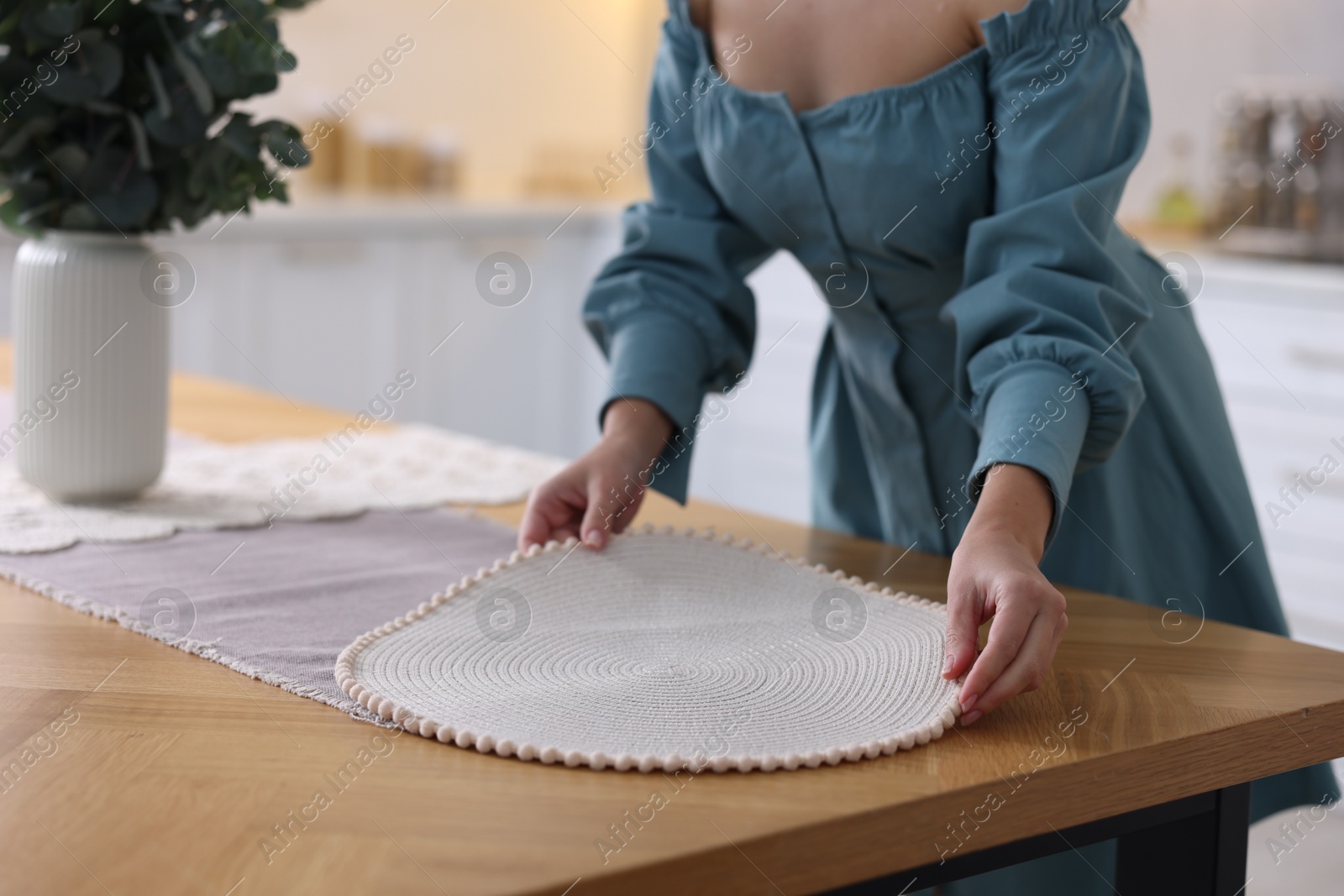 Photo of Woman setting table for dinner at home, closeup