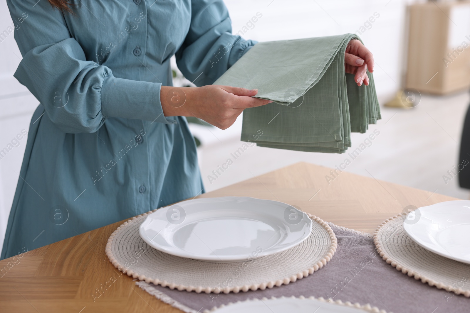 Photo of Woman setting table for dinner at home, closeup