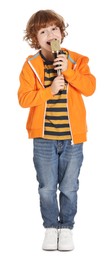 Photo of Little boy with microphone singing on white background