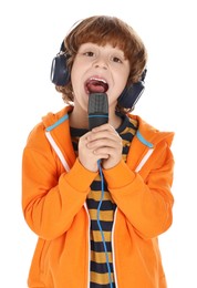 Little boy with microphone and headphones singing on white background