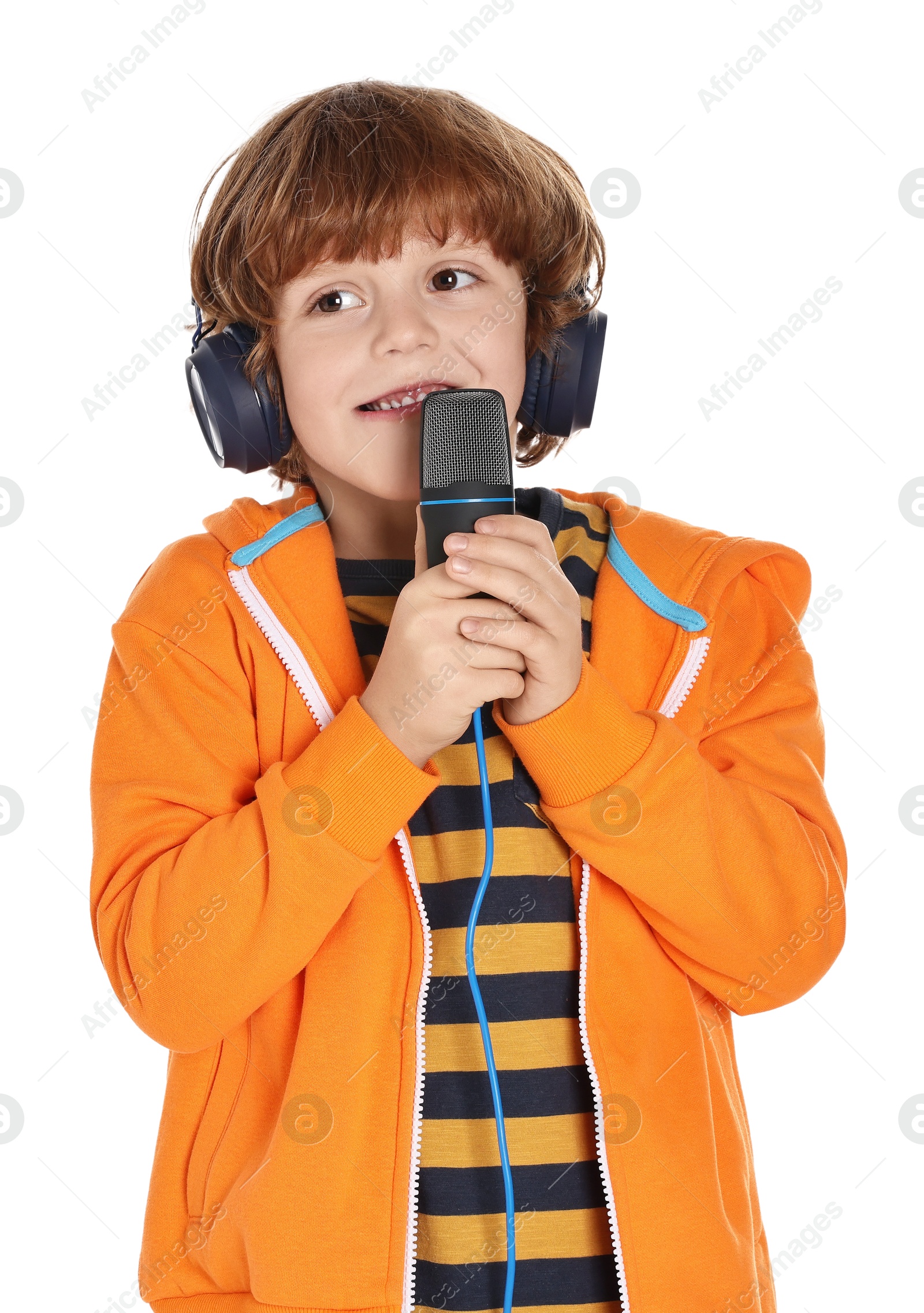 Photo of Little boy with microphone and headphones on white background