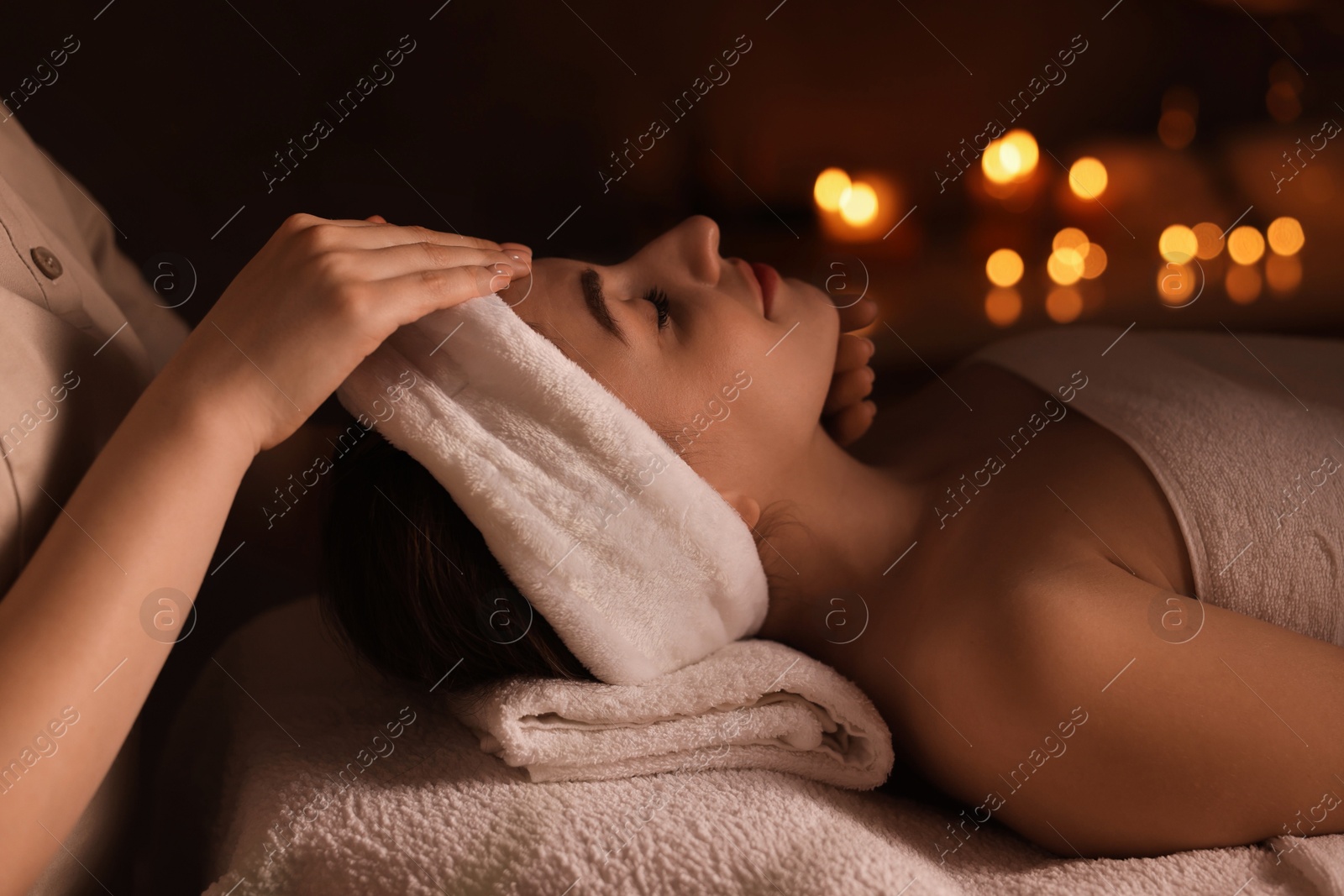 Photo of Young woman receiving massage in spa salon