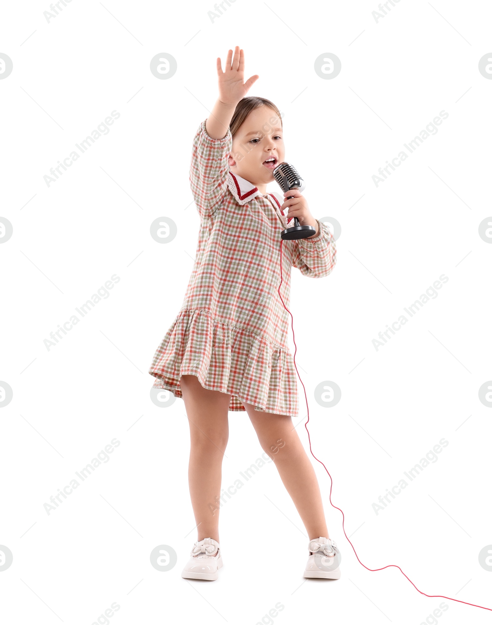 Photo of Cute girl with microphone singing on white background