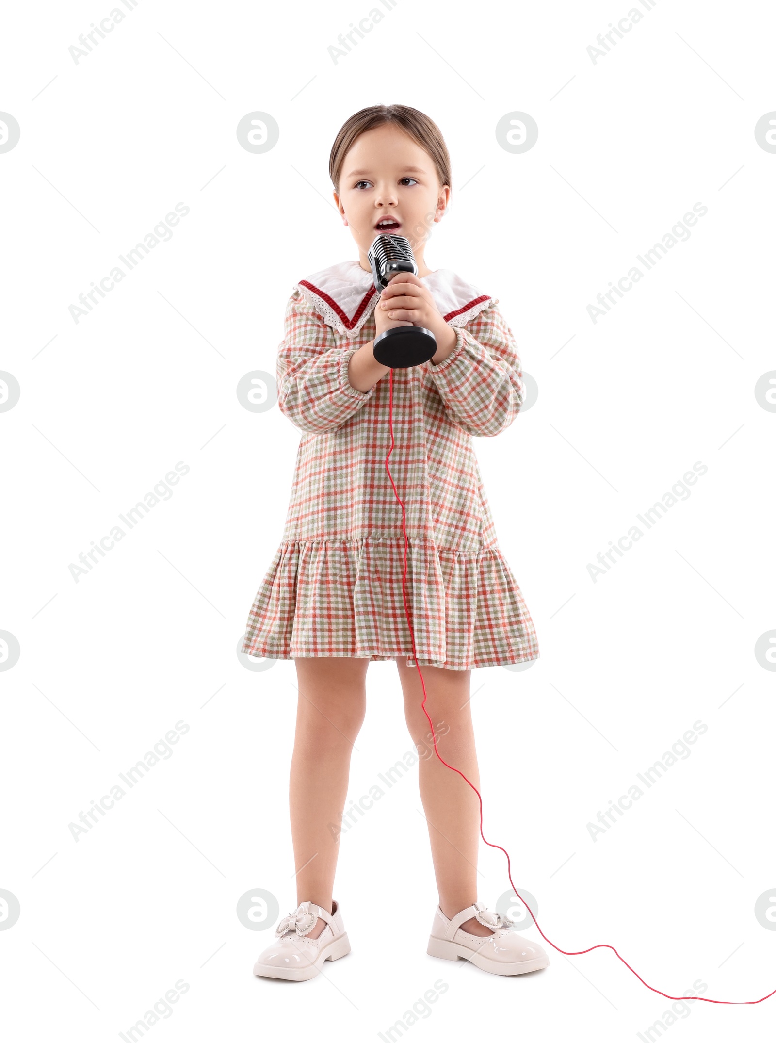 Photo of Cute girl with microphone singing on white background