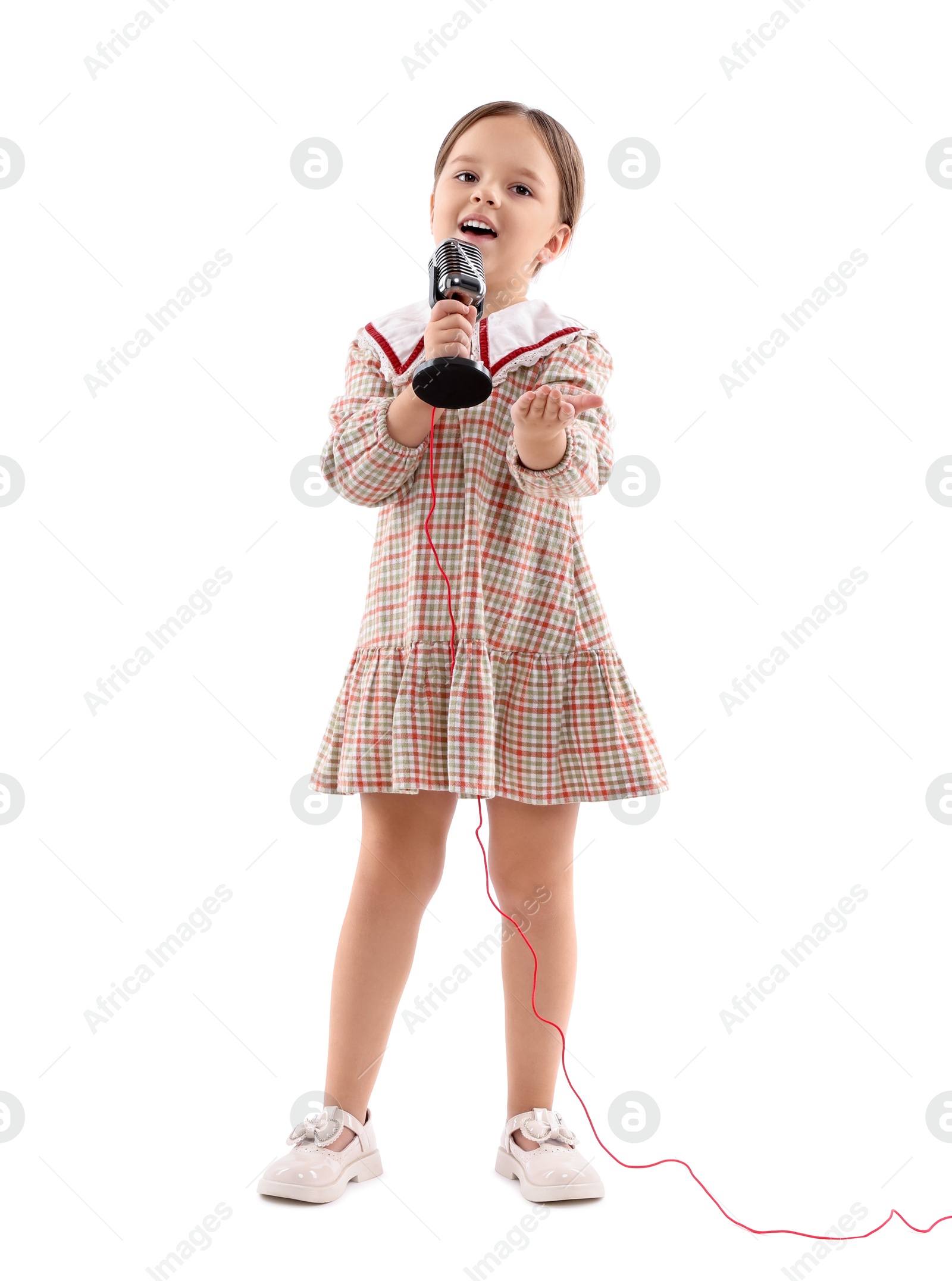 Photo of Cute girl with microphone singing on white background