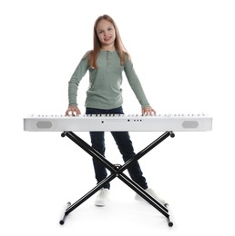 Photo of Cute girl playing synthesizer on white background