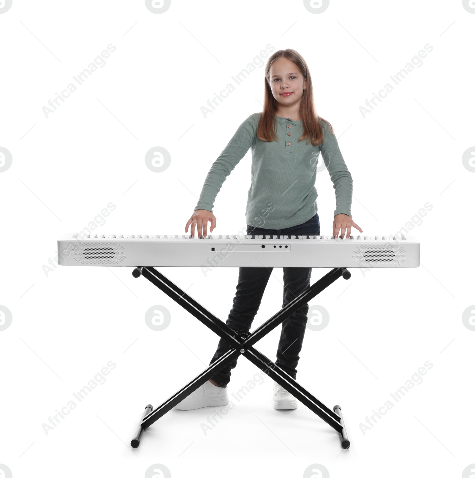 Photo of Cute girl playing synthesizer on white background