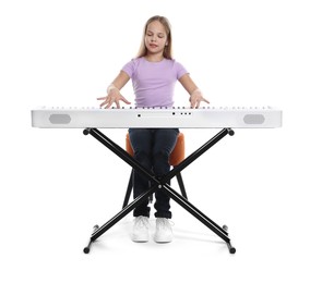 Photo of Cute girl playing synthesizer on white background