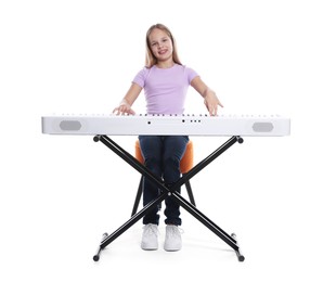 Photo of Cute girl playing synthesizer on white background